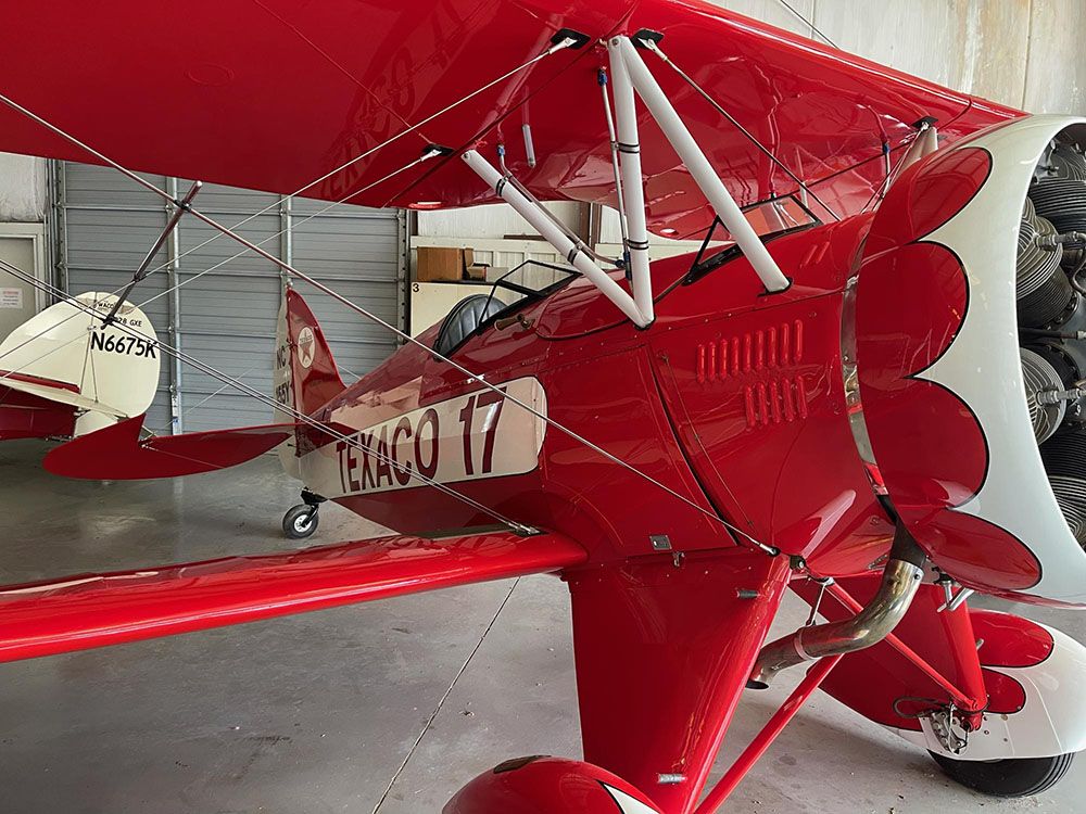 three-quarters view of the red-and-white texaco 17 in its hangar in st. louis